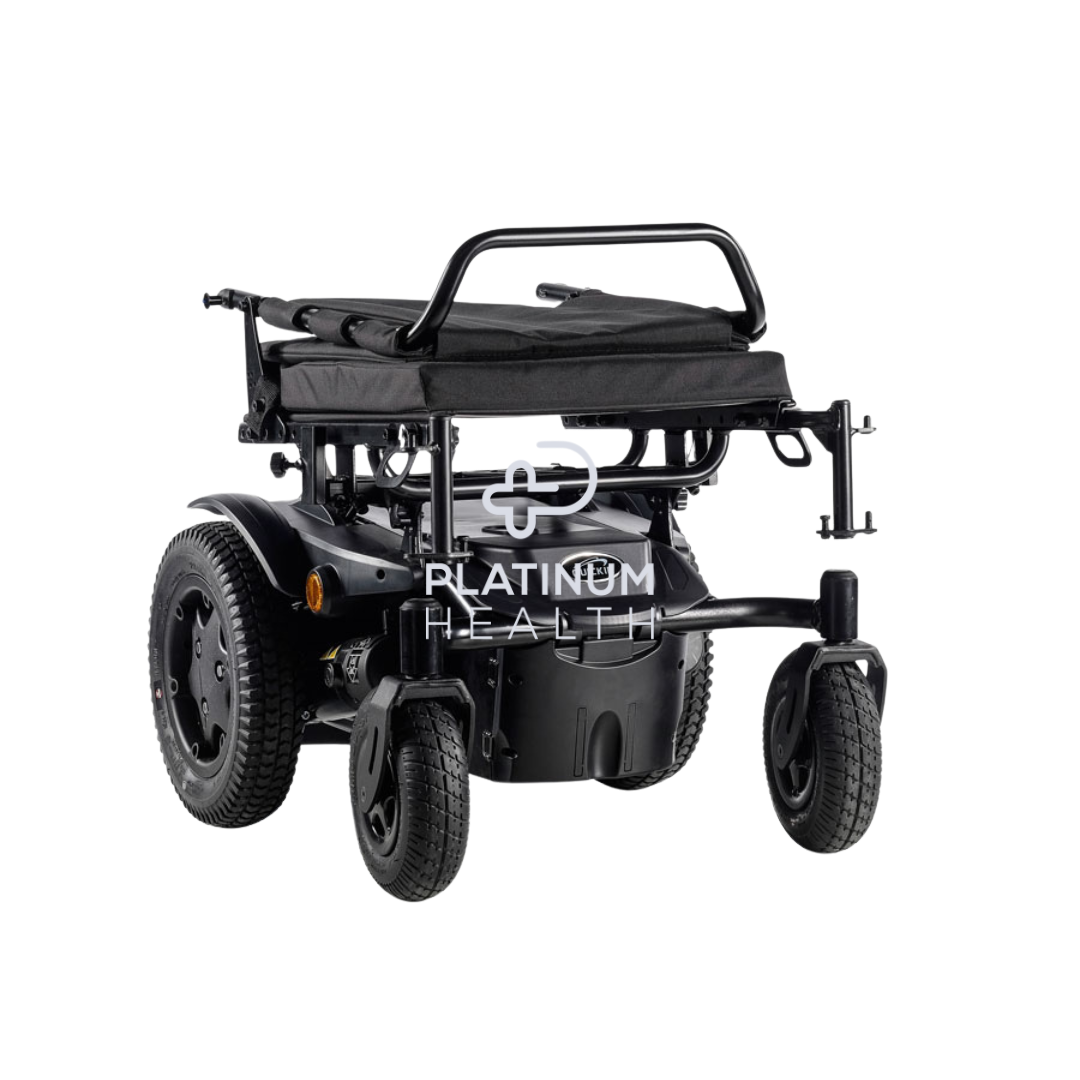 Folded power wheelchair in black with sturdy rear wheels and compact design for easy portability, ideal for mobility assistance and travel. Image includes an overlay of the Platinum Health logo.